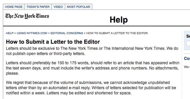 Person writing article on laptop computer