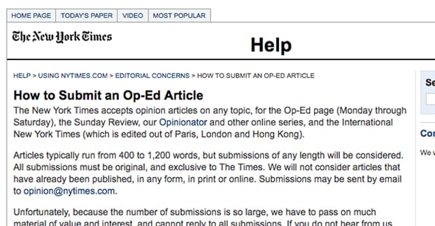 Person writing article on laptop computer