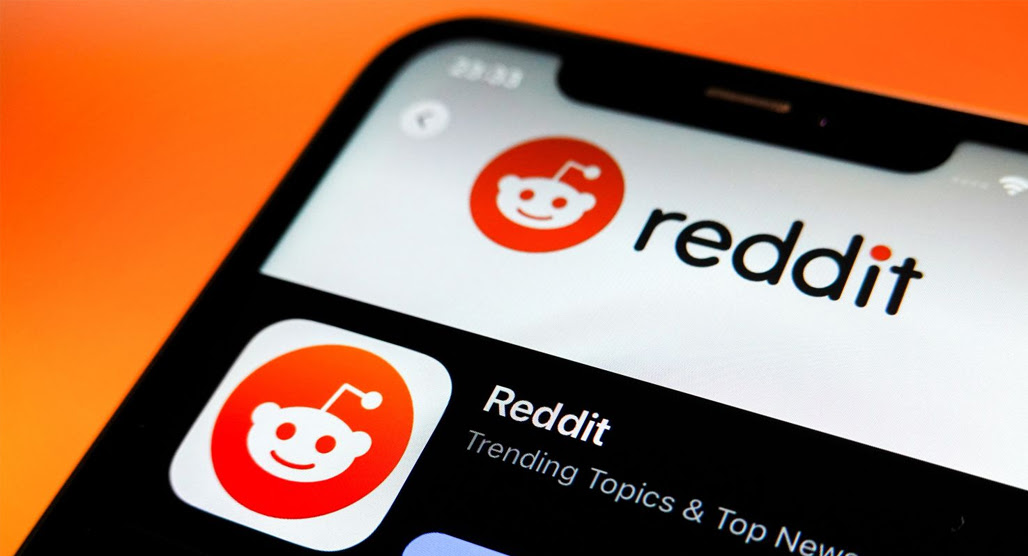 Person frustrated while browsing Reddit on laptop