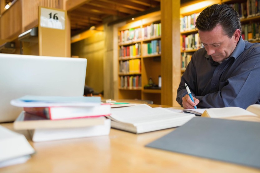 Person analyzing keyword data on paper